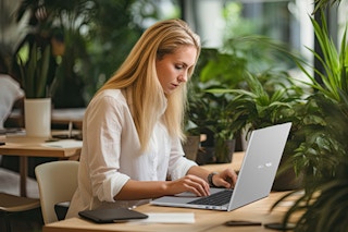Woman working on laptop.