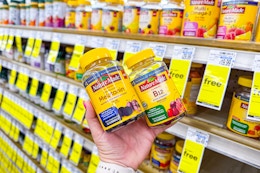 person holding 2 bottles of nature made vitamins