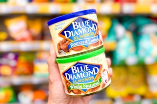 hand holding blue diamond almond cans