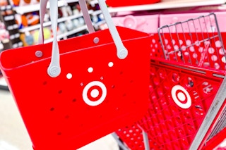 hand holding bullseye bogg bag next to target cart