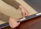 a person putting Command strips on a picture frame