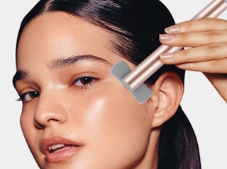 a person using a facial wand on their face