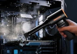 an air duster blowing dust off of a machine