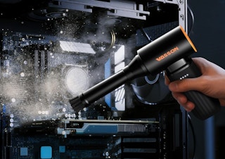 an air duster blowing dust off of a machine