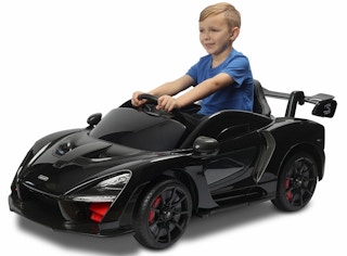 child riding in a black mclaren ride on car