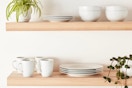Amazon Basics 16-Piece Porcelain Kitchen Dinnerware Set on a floating shelf.