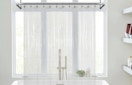 a clear shower curtain liner in front of a bathtub