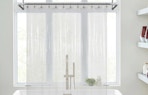 a clear shower curtain liner in front of a bathtub