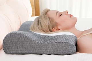 a woman laying on a cervical neck pillow