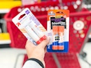 hand holding 2 glue sticks at target