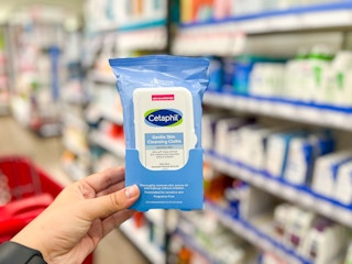 hand holding pack of cetaphil wipes in target aisle