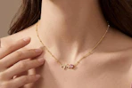 woman wearing pink heart necklace