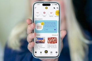 someone holding up a phone showing the new KCL app