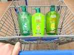 3 garnier shampoo and conditioner bottles sitting in a walmart cart