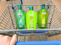 3 garnier shampoo and conditioner bottles sitting in a walmart cart