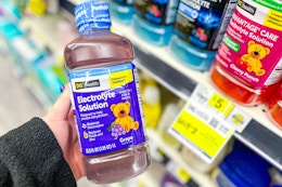 hand holding up a bottle of dg health electrolyte solution