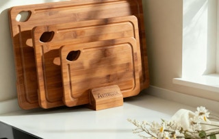 bamboo cutting boards on a counter with flowers