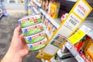 person holding 4 cans of bumble bee tuna