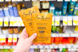 hand holding two sheamoisture hair masks