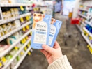 person holding 2 packages of biore pore strips in an aisle