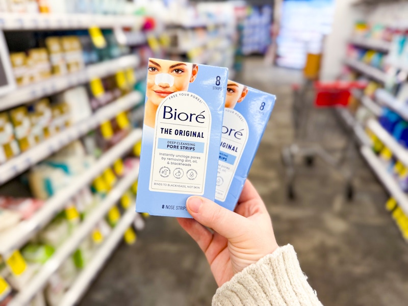 person holding 2 packages of biore pore strips in an aisle