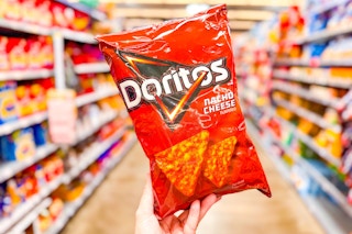 hand holding a bag of doritos