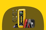 A yellow rectangular jump starter has a red clamp and a black clamp for use on a car battery. It also has 2 USB cables included.