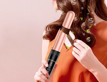a person using a curling iron on their hair 