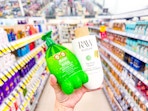 hand holding two raw sugar shampoos in walgreens
