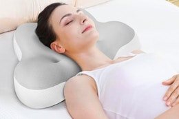 a woman using a cervical pillow