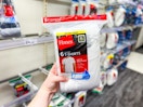 hand holding a 6-pack of hanes men's tees at target