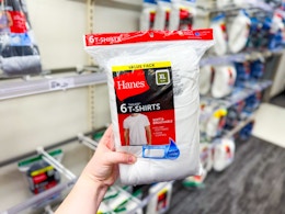 hand holding a 6-pack of hanes men's tees at target