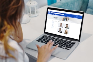 woman looks at a computer screen with best buy gift ideas webpage pulled up