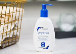 a bottle of facial cleanser on a counter 