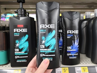 hand holding a bottle of axe body wash
