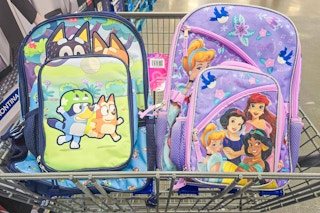 bluey and disney princess themed backpacks in a cart