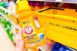 hand holding arm & hammer laundry detergent