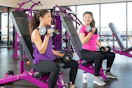 teens using free weights in a planet fitness gym