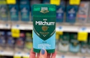 person holding Mitchum men deodorant in aisle