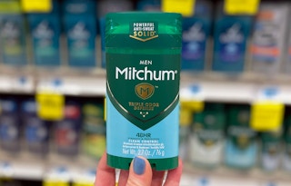 person holding Mitchum men deodorant in aisle