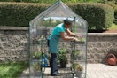 a woman in a miracle greenhouse
