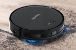 a robot vacuum sweeping up dirt