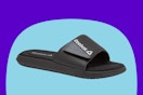 Stock image of a black mens Reebok slide sandals