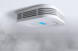 a smoke detector on a ceiling
