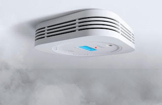 a smoke detector on a ceiling