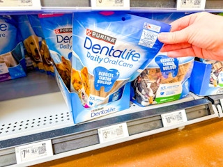 hand pulling purina dentalife dog treats off walmart shelf