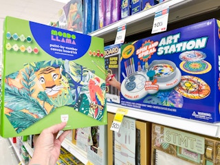 hand holding an art set in front of crayola clearance at target