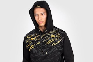 a man wearing a venum hoodie