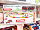 hand grabbing a mario kart racing set off a target shelf