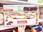 hand grabbing a mario kart racetrack set off a target shelf